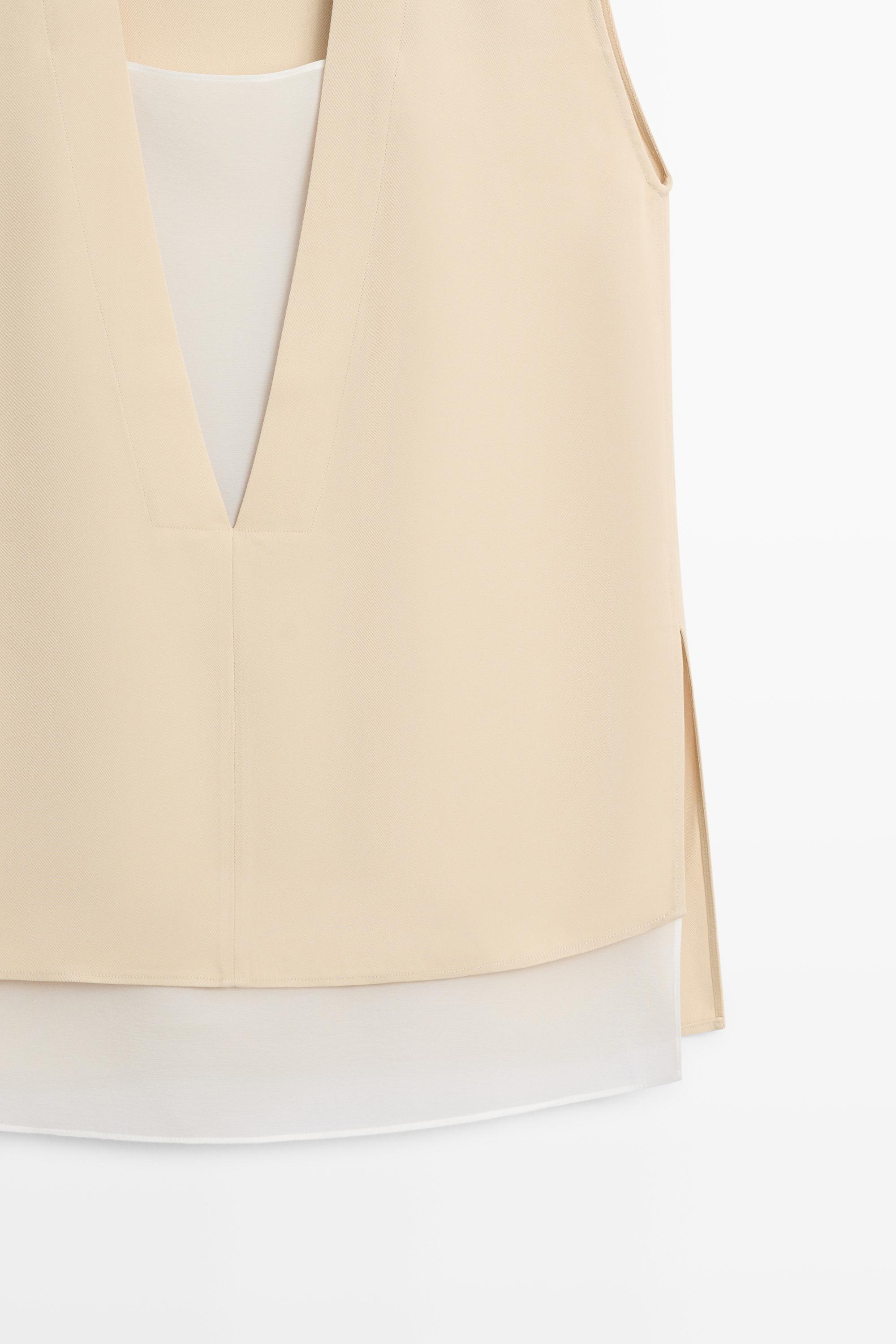 Flowing double-layer top with contrast detail
